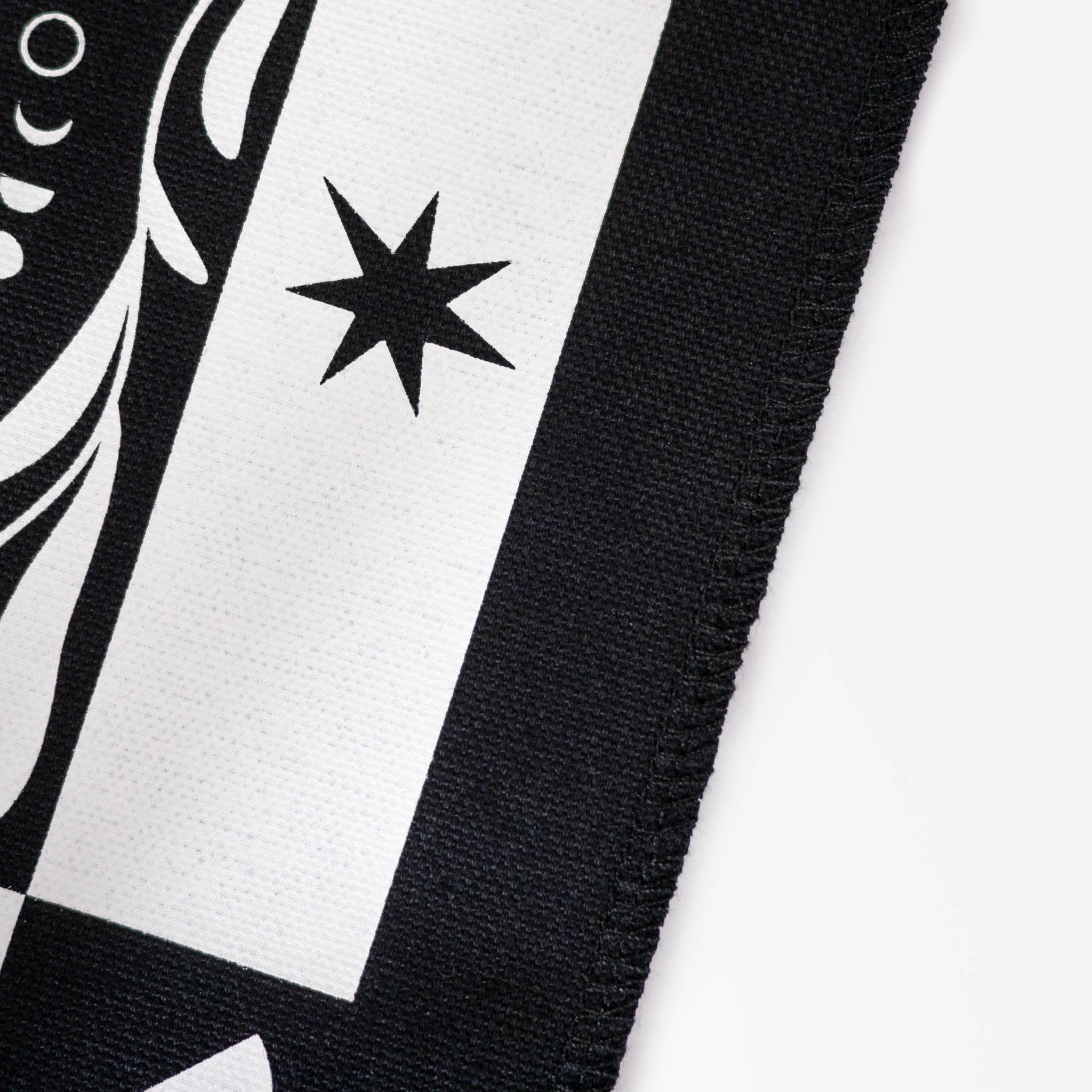 Close up of the neat, overlocked edge of the black moon patch with white printed star design